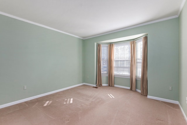 unfurnished room featuring crown molding, light colored carpet, and baseboards