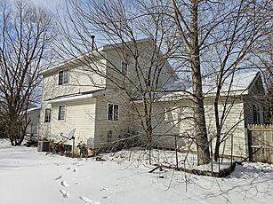 snow covered property featuring fence