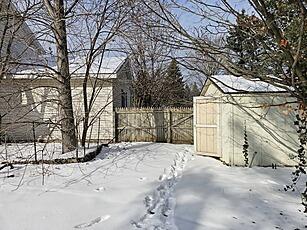 snowy yard featuring fence