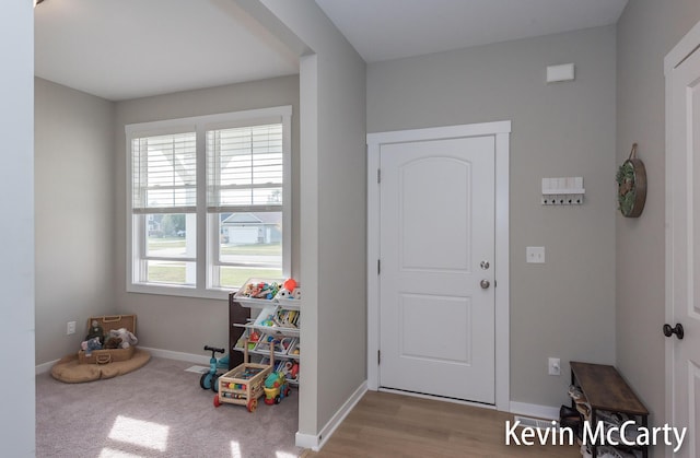 entryway with wood finished floors and baseboards