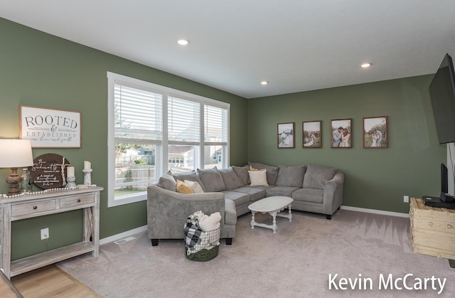 carpeted living room featuring recessed lighting, visible vents, and baseboards