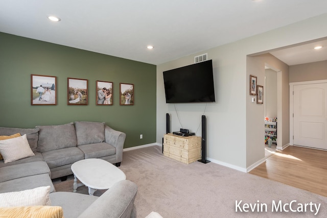 living room with recessed lighting, carpet flooring, visible vents, and baseboards