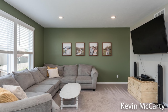 living room with light carpet, recessed lighting, visible vents, and baseboards