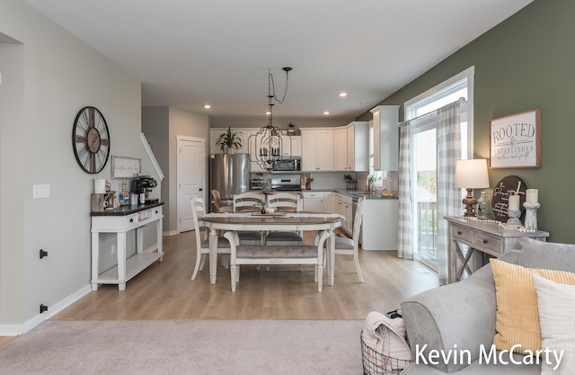 dining space featuring baseboards, recessed lighting, and light wood-style floors