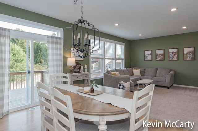 dining space with recessed lighting, visible vents, light colored carpet, a chandelier, and baseboards