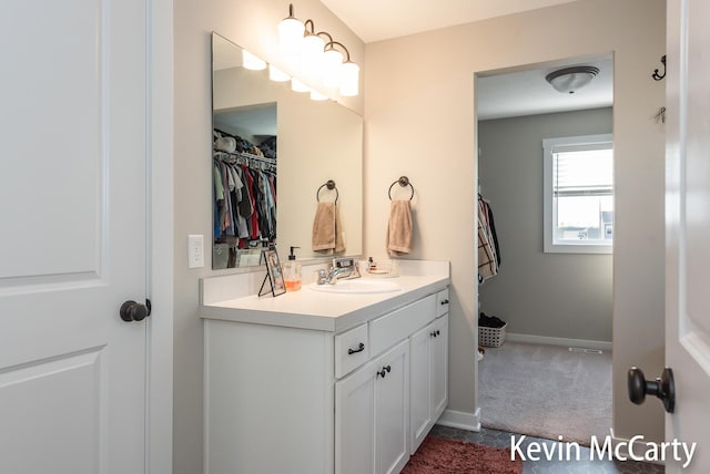 bathroom with vanity and baseboards