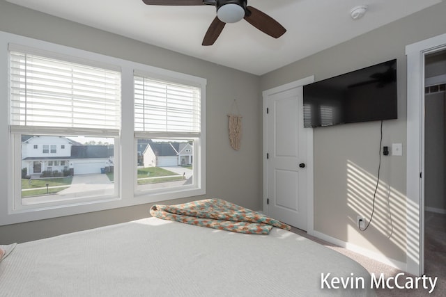 unfurnished bedroom with a ceiling fan and carpet flooring