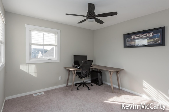 office featuring a ceiling fan, baseboards, visible vents, and carpet flooring