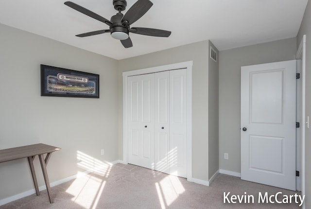 unfurnished bedroom with visible vents, baseboards, a closet, and carpet flooring