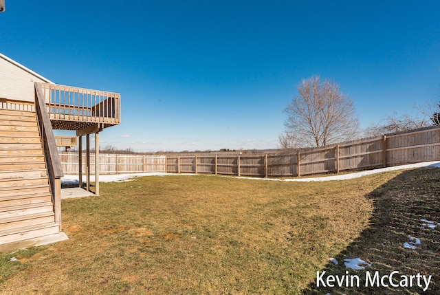 view of yard with a fenced backyard, stairs, and a wooden deck