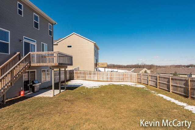 view of yard with a patio area, a fenced backyard, stairway, and a deck