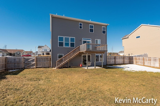 rear view of property with a yard, a patio area, and a fenced backyard