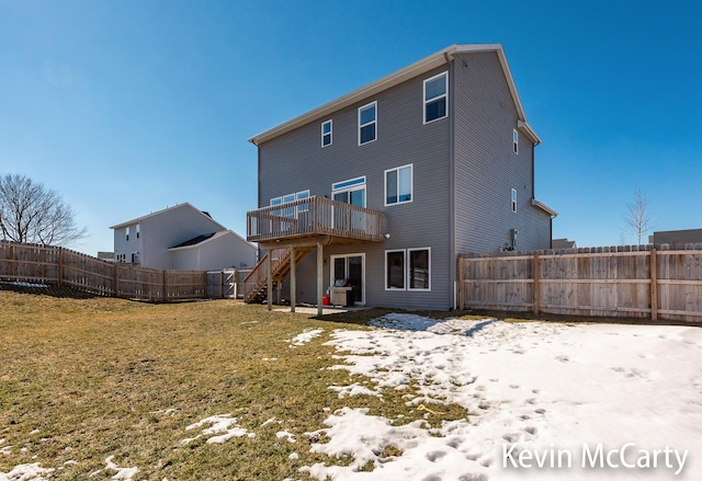 back of house featuring a fenced backyard, stairs, a lawn, and a wooden deck