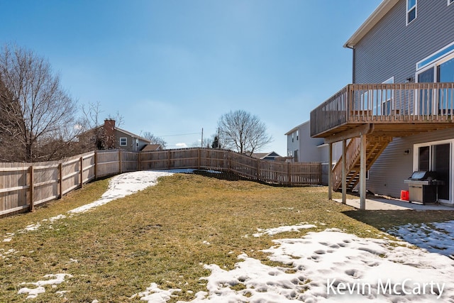 view of yard featuring a deck, stairway, and a fenced backyard