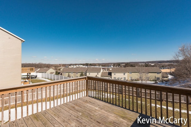 wooden deck featuring a residential view and fence