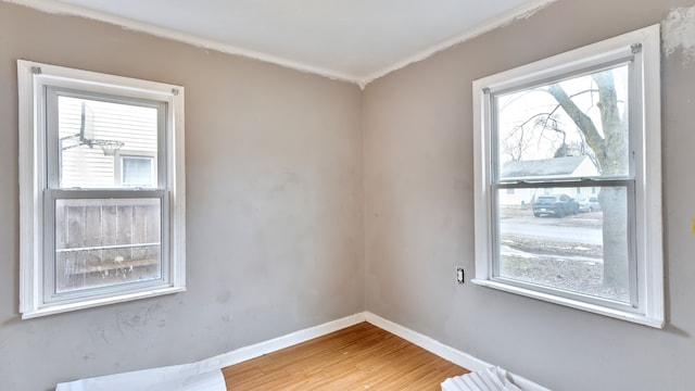 empty room featuring light wood-style flooring and baseboards