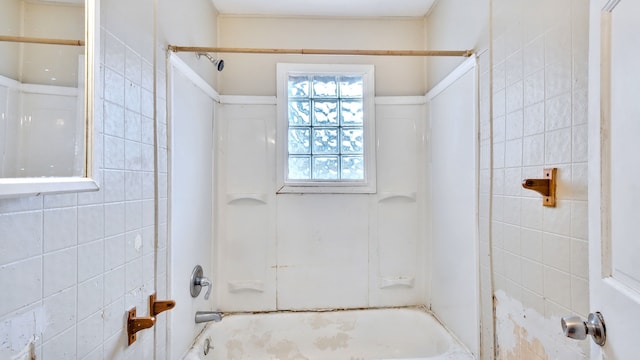 full bath with shower / bathing tub combination and tile walls