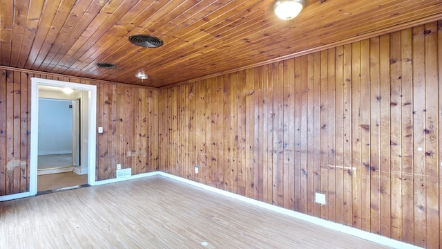 unfurnished room with wood ceiling, visible vents, baseboards, and wood finished floors