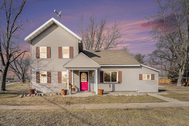 traditional-style home with roof with shingles