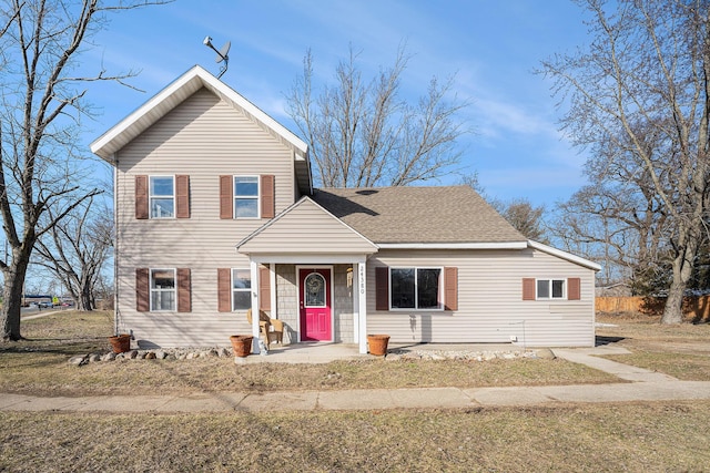 traditional home featuring roof with shingles