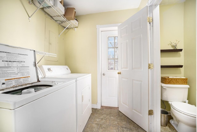 washroom with laundry area, washer and clothes dryer, and baseboards