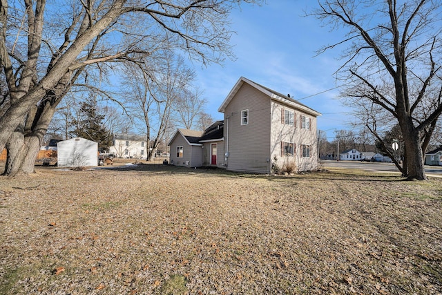 view of home's exterior with an outdoor structure