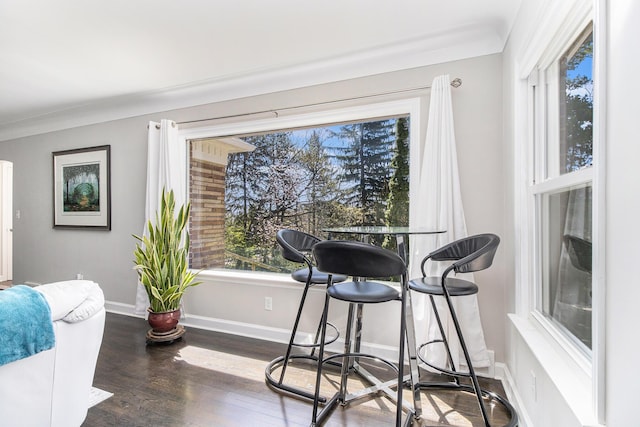 dining room with baseboards and wood finished floors