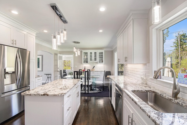 kitchen featuring stainless steel appliances, dark wood-type flooring, a sink, and white cabinetry