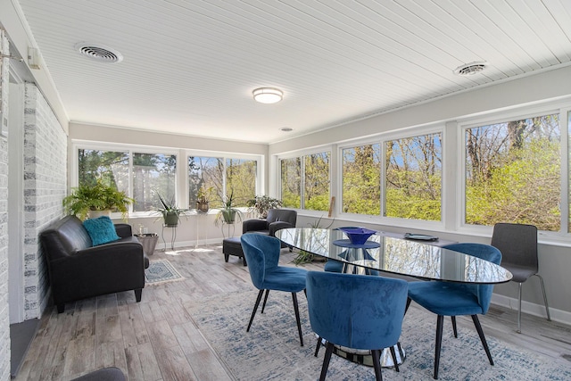 sunroom featuring plenty of natural light and visible vents