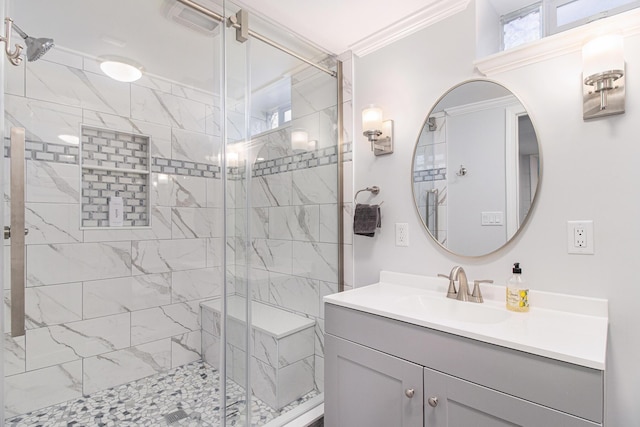 bathroom with ornamental molding, a stall shower, and vanity