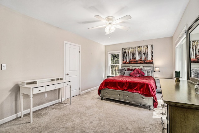 carpeted bedroom with a ceiling fan and baseboards