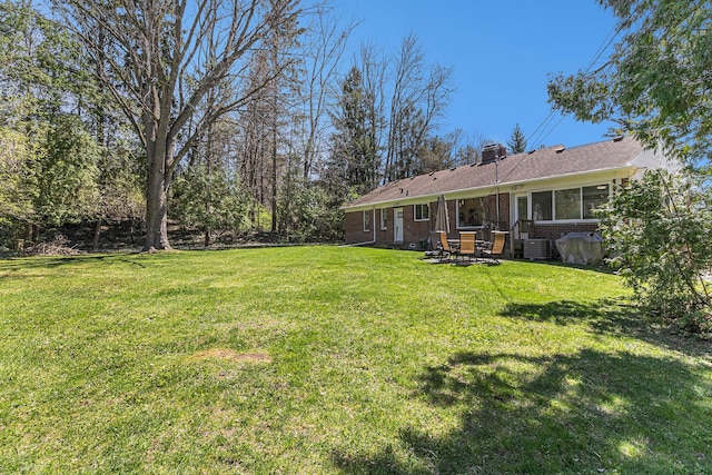 view of yard with a patio area and central AC