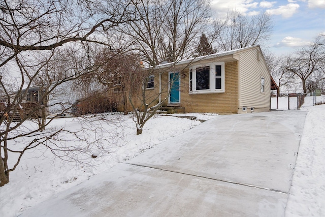 view of front of property with brick siding and fence