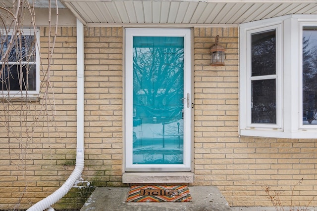 property entrance with brick siding