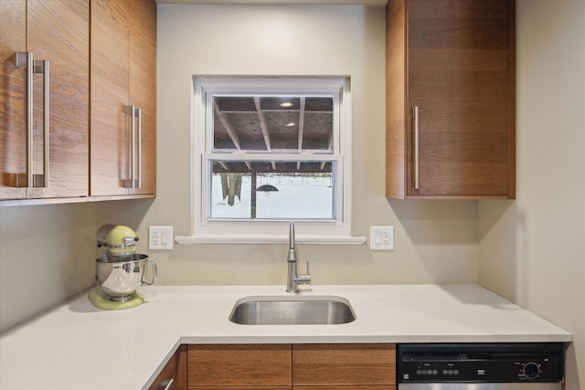 kitchen with a sink, brown cabinetry, dishwasher, and light countertops