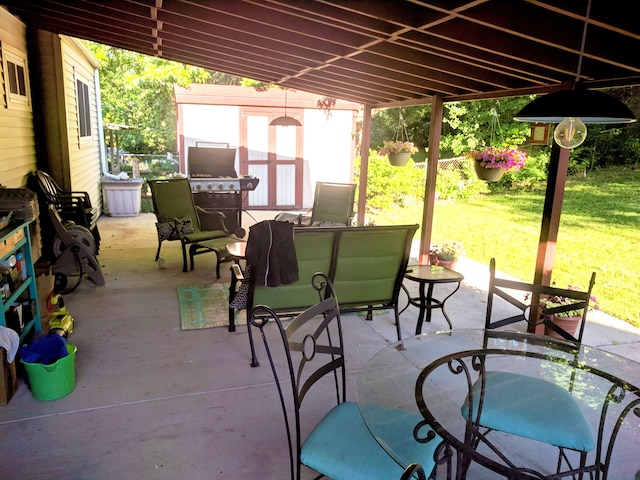 view of patio with an outdoor structure and a storage unit