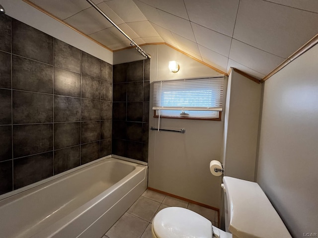 bathroom with lofted ceiling, shower / bath combination, toilet, and tile patterned floors