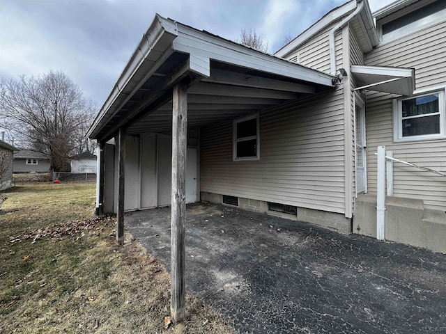 view of side of home with an attached carport