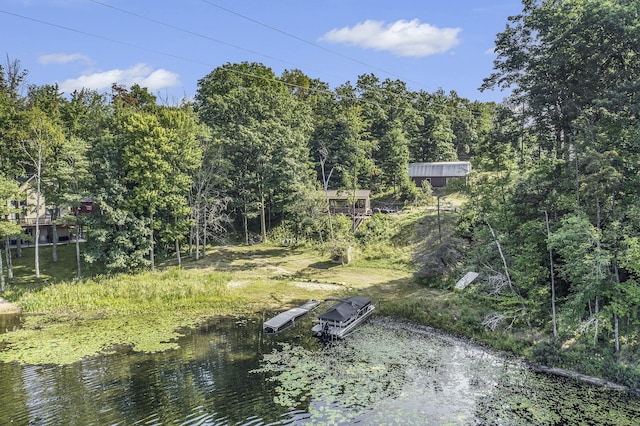 exterior space with a forest view and a water view