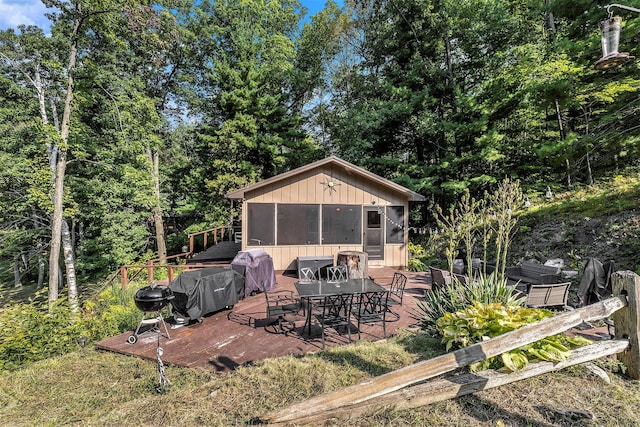 view of patio with outdoor dining area, grilling area, and a wooden deck