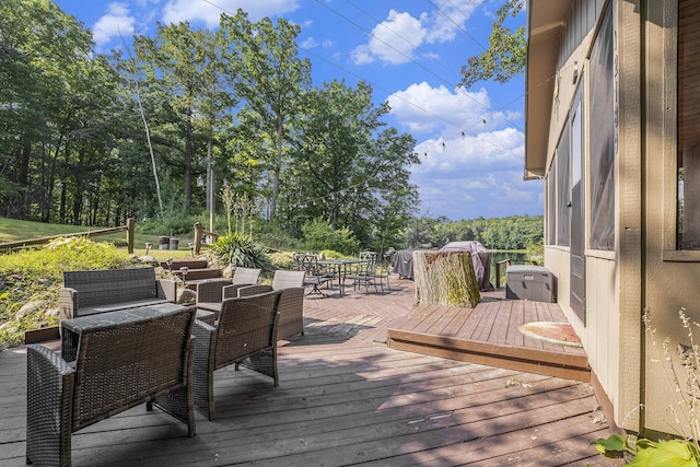 wooden deck with outdoor dining area and outdoor lounge area