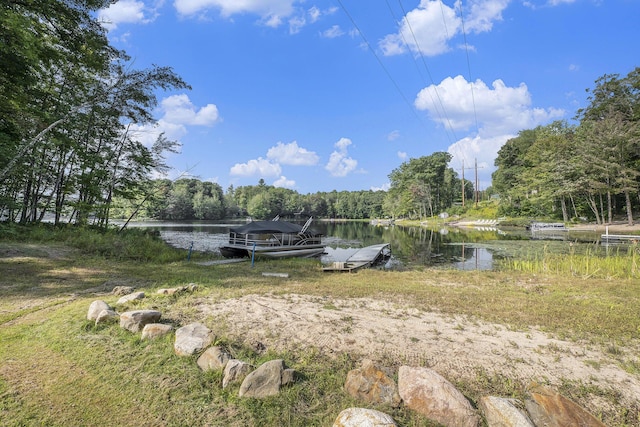 view of yard featuring a water view and a floating dock