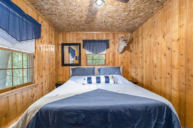 bedroom featuring wooden walls