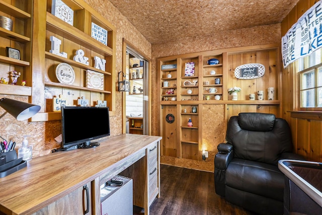 office area with dark wood-type flooring and brick ceiling