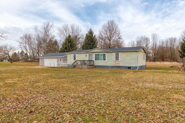 back of house featuring crawl space, a garage, and a yard