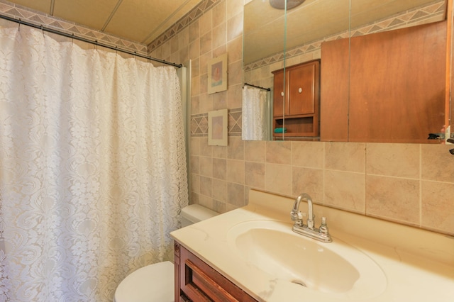 bathroom with toilet, tasteful backsplash, tile walls, and vanity