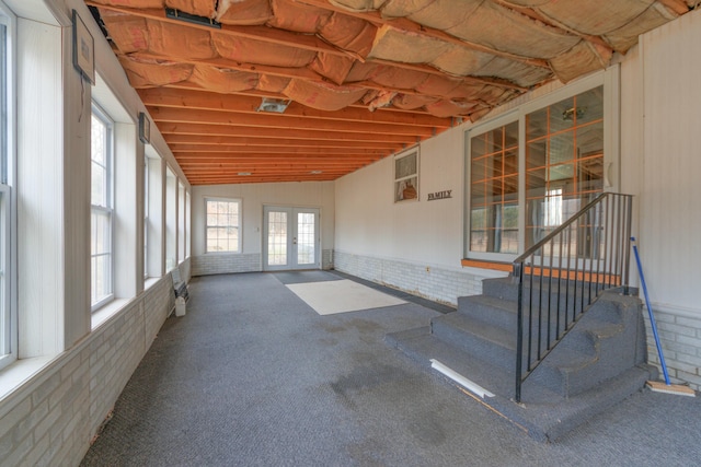 unfurnished sunroom with french doors