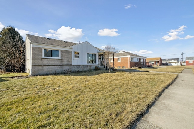 single story home with brick siding and a front lawn