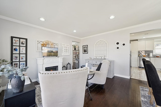 dining area with dark wood-style floors, a lit fireplace, baseboards, and crown molding