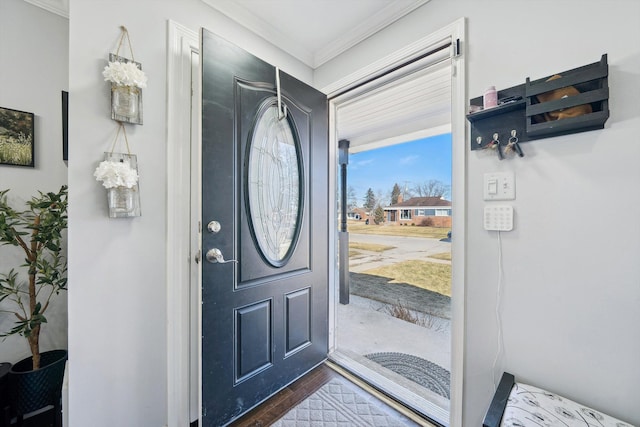 entryway featuring crown molding and dark wood-style flooring